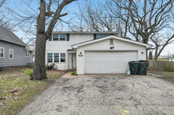 a view of a house with a yard and garage