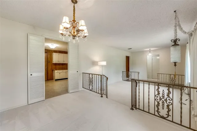 a view of a hallway with a chandelier