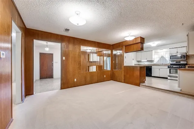 a view of a kitchen with a sink and a refrigerator