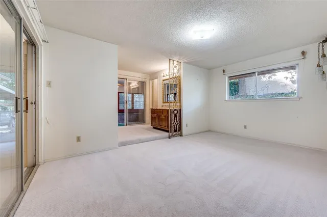 an empty room with closet and mirror