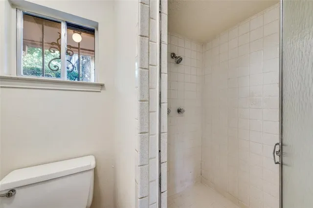 a bathroom with a toilet and a shower