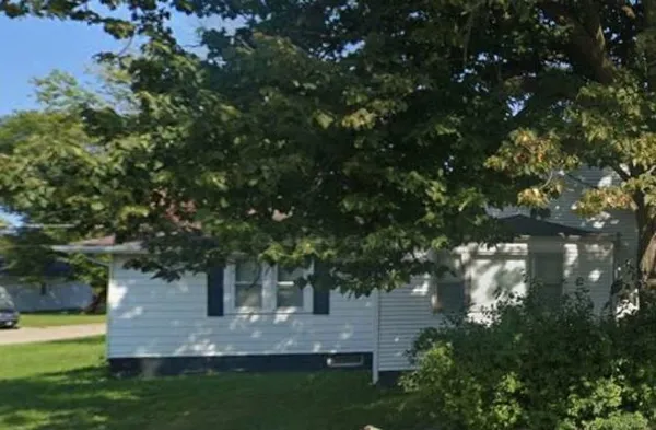 a view of a tree in front of a house with a tree