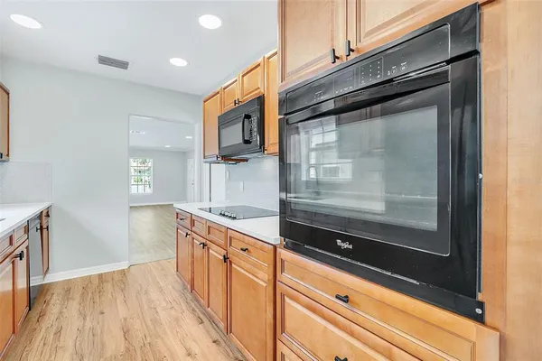 a kitchen with granite countertop a refrigerator and a stove
