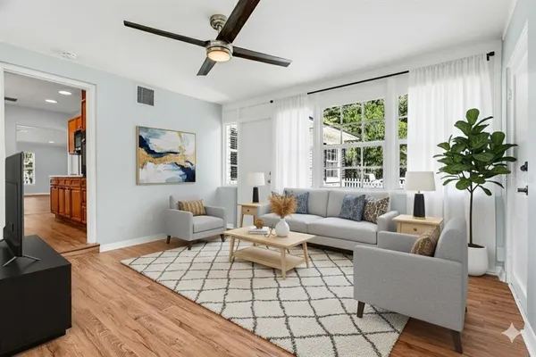 a living room with furniture and a potted plant