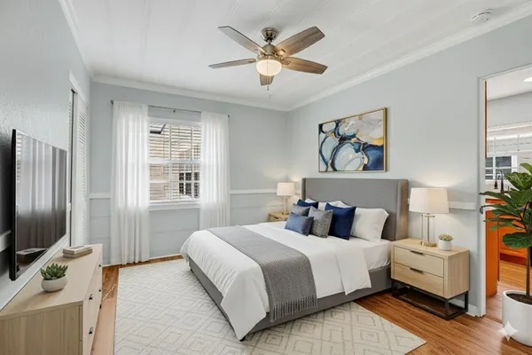 a bedroom with a bed and a flat screen tv