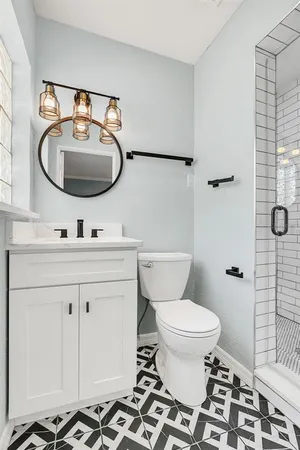 a bathroom with a toilet a sink and a mirror