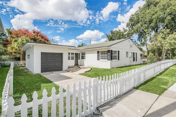 a view of a house with wooden fence
