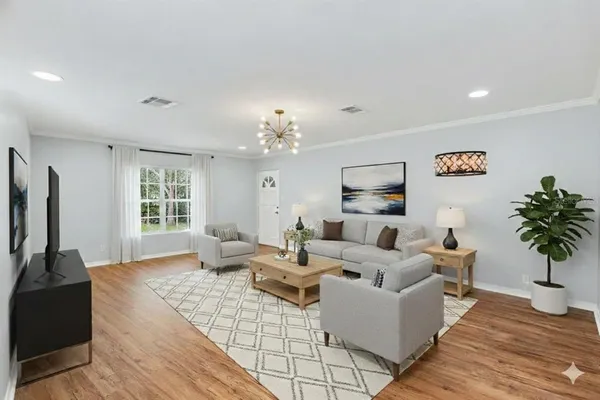 a living room with furniture large window and flat screen tv