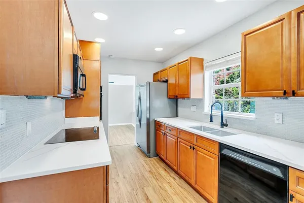 a kitchen with a sink and a large window