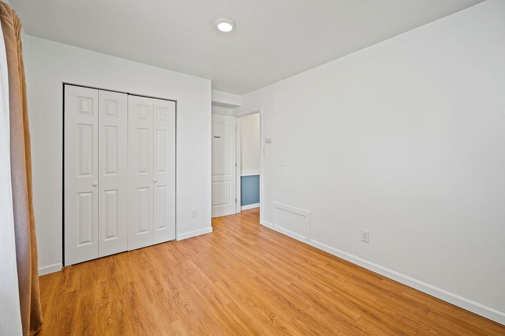 181 Elm Avenue Grand Junction, CO 81501 - Photo 18 of 25 a view of an empty room with wooden floor