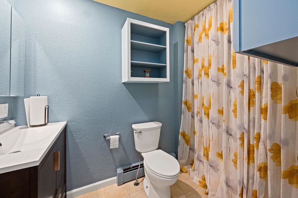 181 Elm Avenue Grand Junction, CO 81501 - Photo 19 of 25 a white toilet sitting next to a bathroom sink