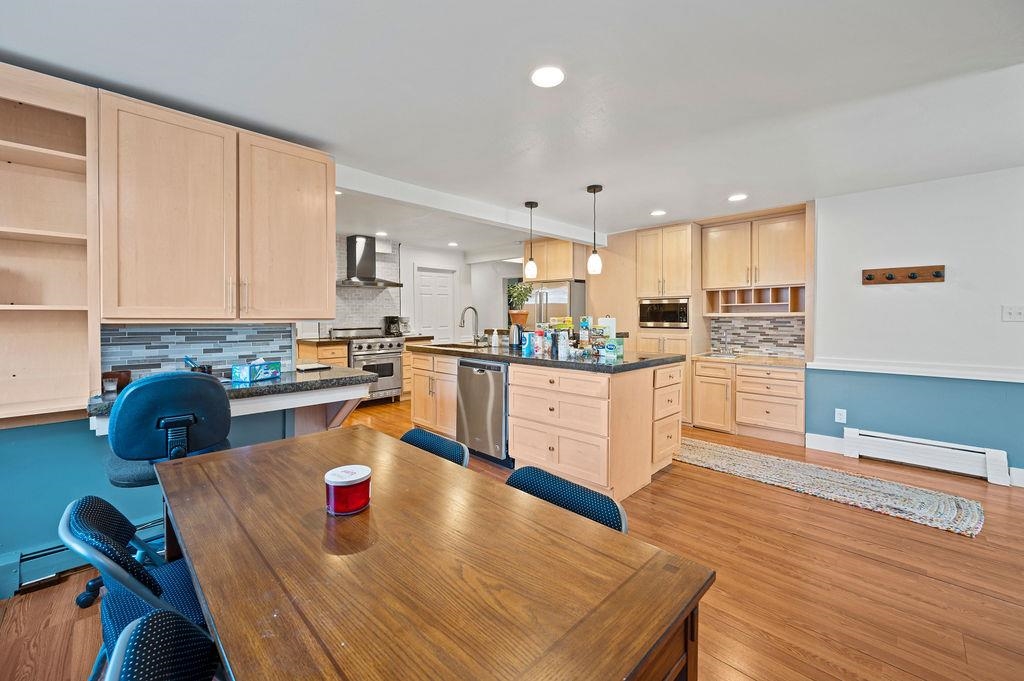 181 Elm Avenue Grand Junction, CO 81501 - Photo 8 of 25 a kitchen with stainless steel appliances granite countertop a stove top oven a sink dishwasher and white cabinets with wooden floor