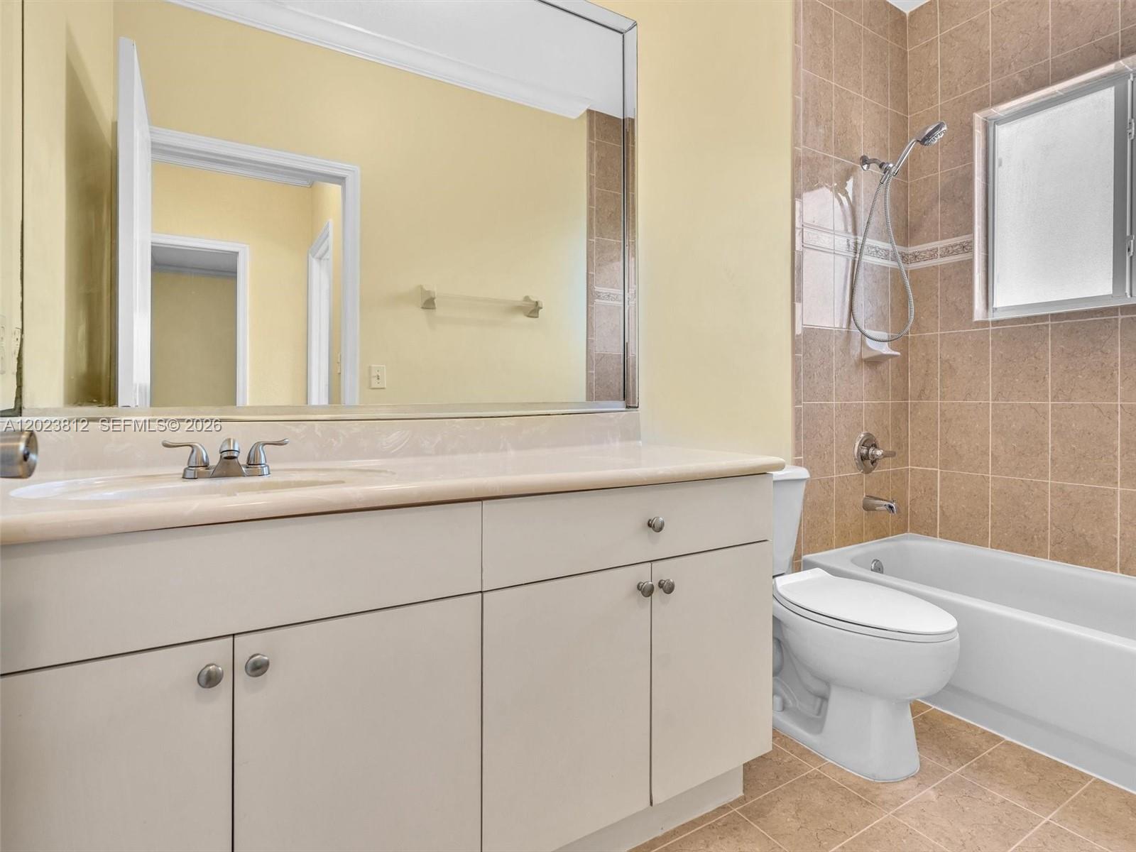 2864 Southwest 138th Path Miami, FL 33175 - Photo 32 of 40 a bathroom with a sink a toilet and a mirror