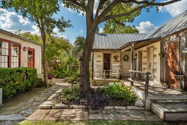 a front view of a house with garden