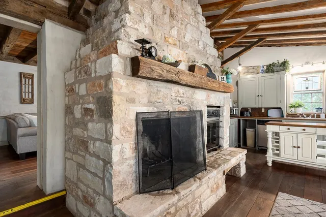 a kitchen with furniture and a fireplace