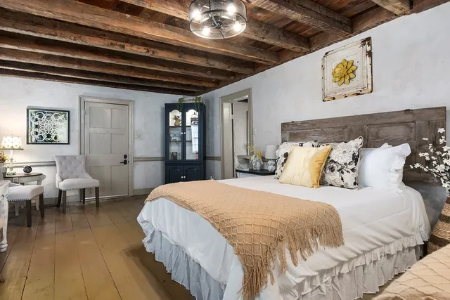 a spacious bedroom with a bed and a table