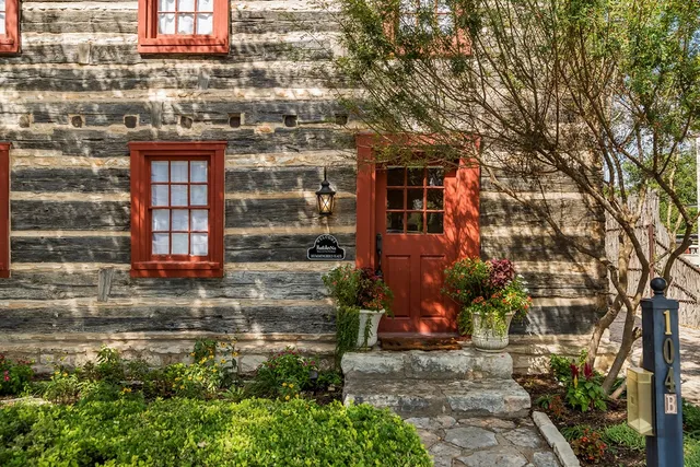 a view of a brick building next to a yard