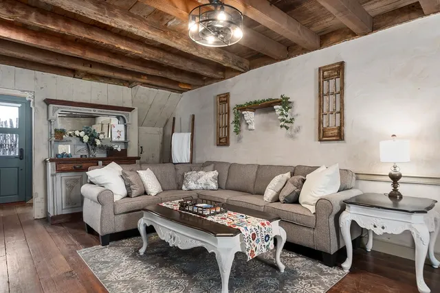 a living room with furniture and a chandelier