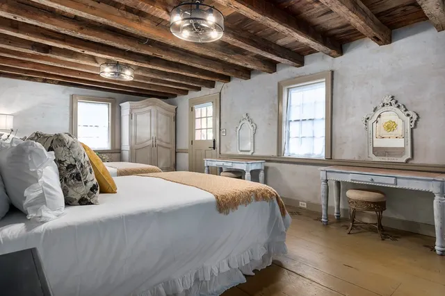 a bed room with a bed and a chandelier