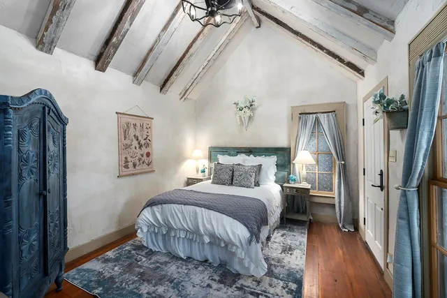 a bedroom with a bed and a mirror