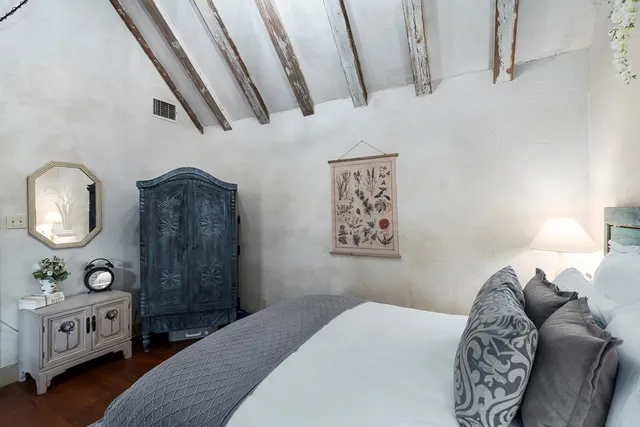 a bedroom with a bed and a mirror