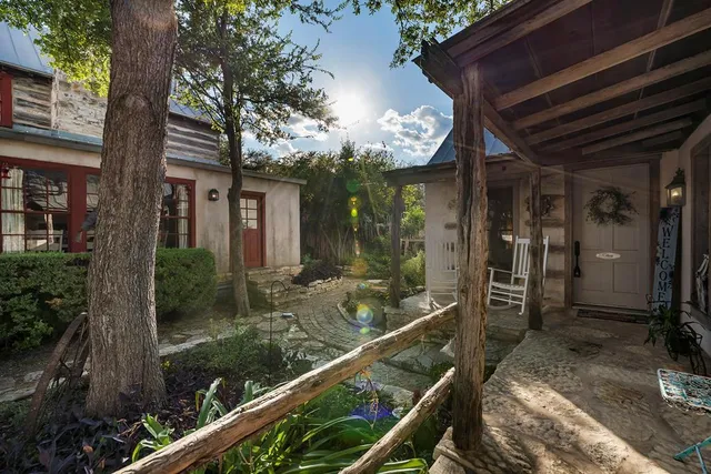 a view of a house with backyard and sitting area