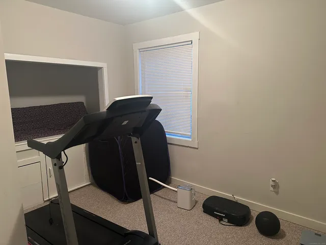a room with gym equipment and a mirror
