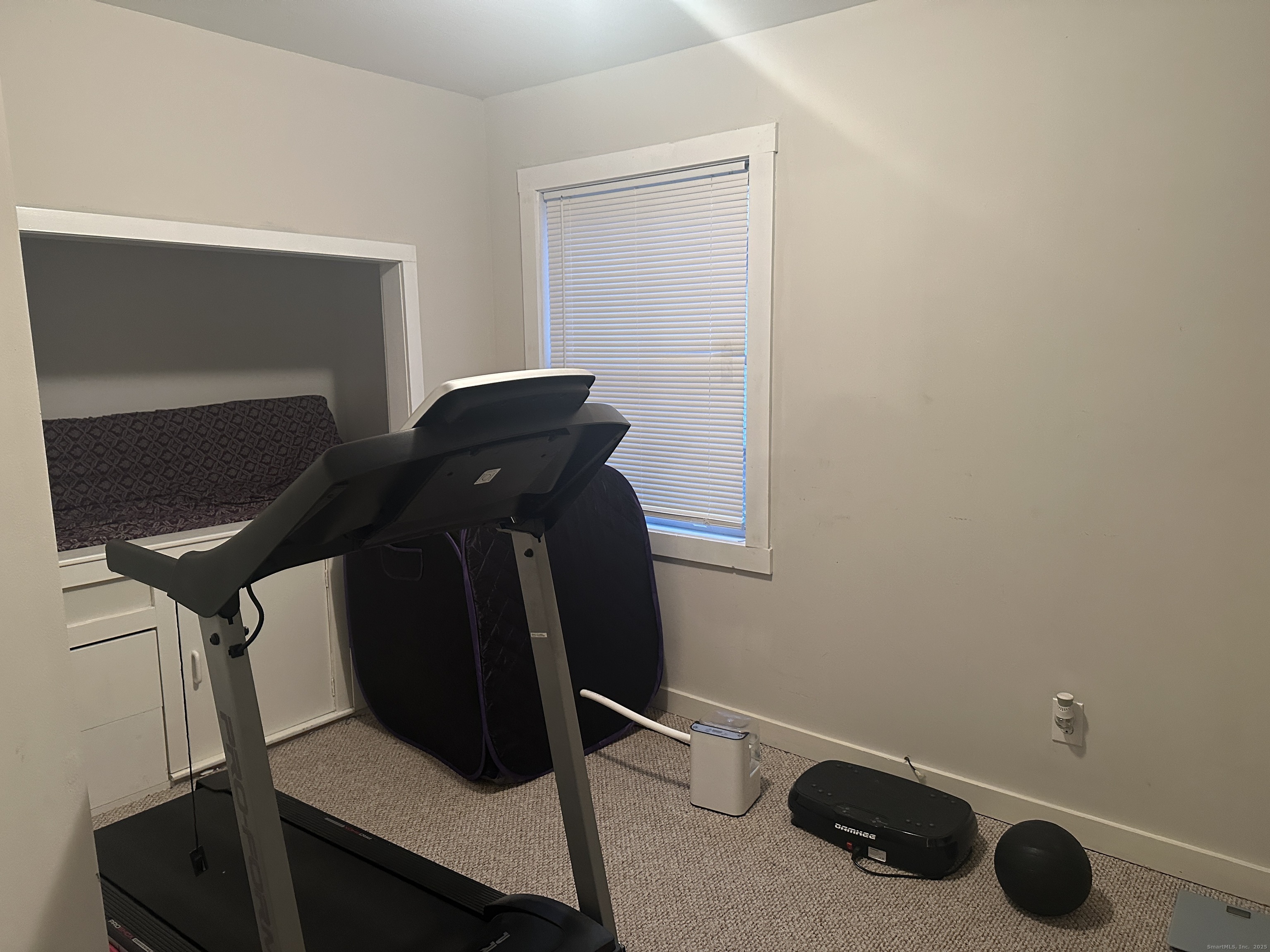30 King Street Wallingford, CT 06492 - Photo 17 of 23 a room with gym equipment and a mirror