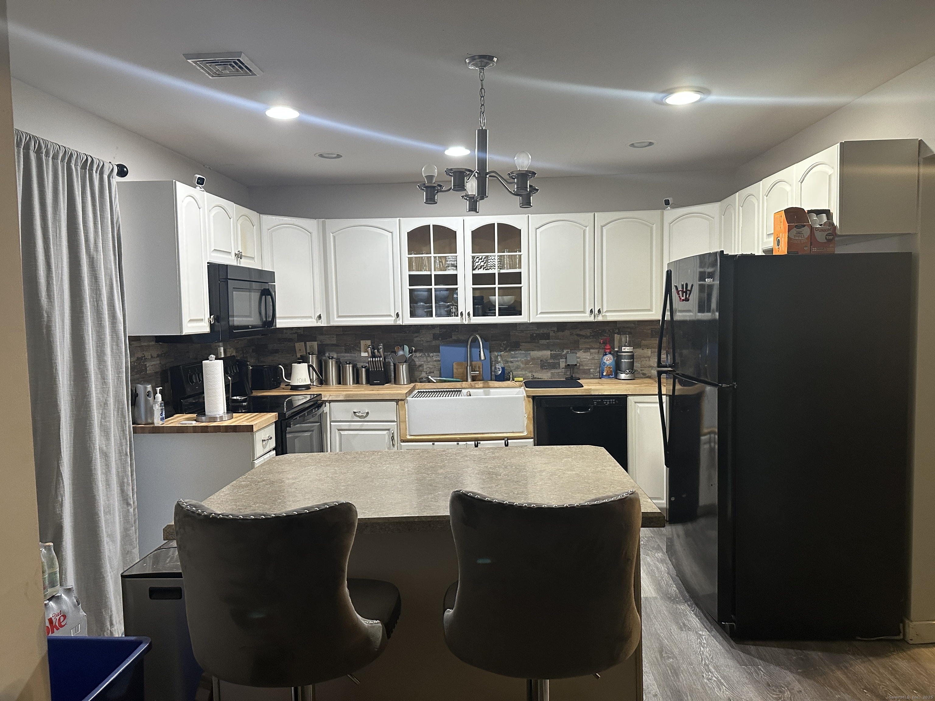 30 King Street Wallingford, CT 06492 - Photo 4 of 23 a kitchen with refrigerator cabinets and chairs