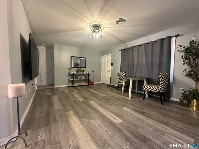 a view of a livingroom with furniture and a ceiling fan