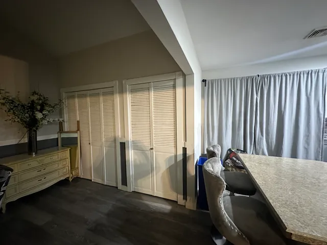 a view of a room with furniture and window