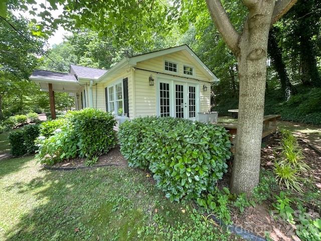 271 Wiggins Road Candler, NC 28715 - Photo 13 of 19 a front view of a house with a yard and trees