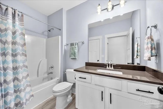 a view of a hallway with wooden floor and entryway