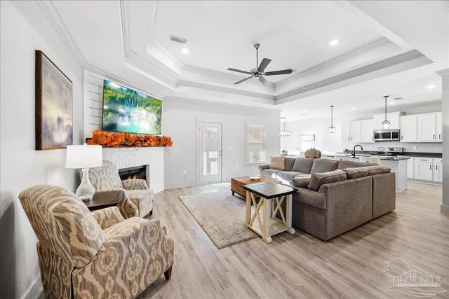 a kitchen with stainless steel appliances granite countertop a stove top oven a sink dishwasher a dining table and chairs with wooden floor