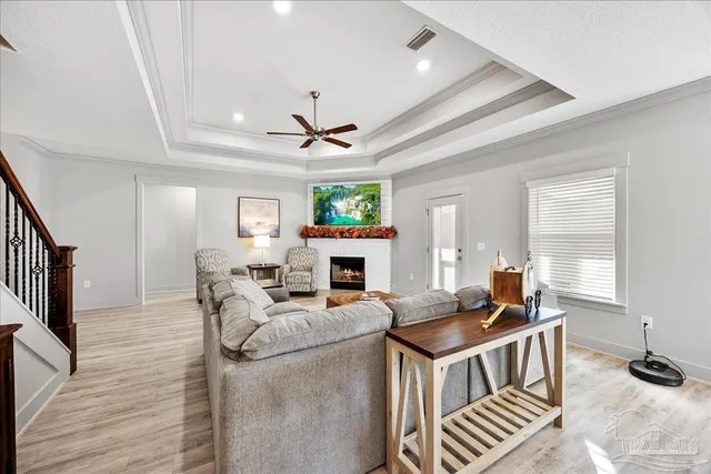 a kitchen with stainless steel appliances granite countertop a sink a stove and a wooden floors