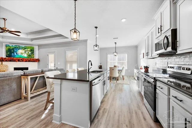 a bedroom with a bed a couch and a flat tv screen on the dresser