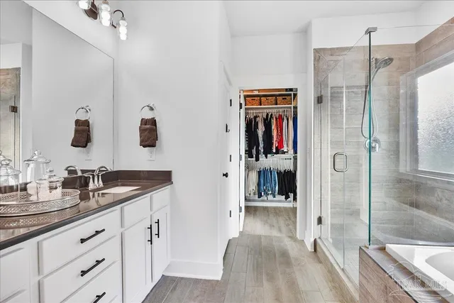 a view of a workspace with furniture and a ceiling fan