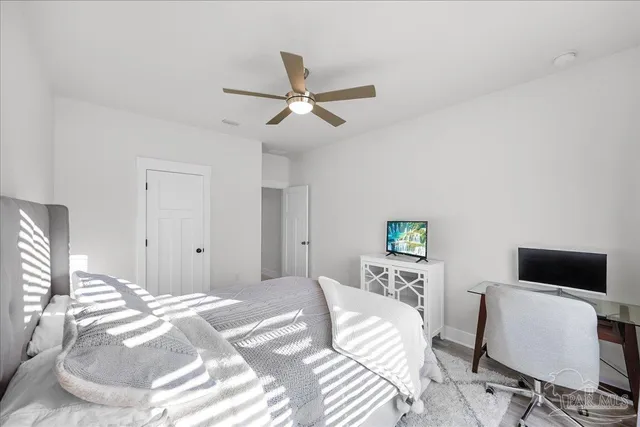 a living room with furniture floor to ceiling window next to a yard