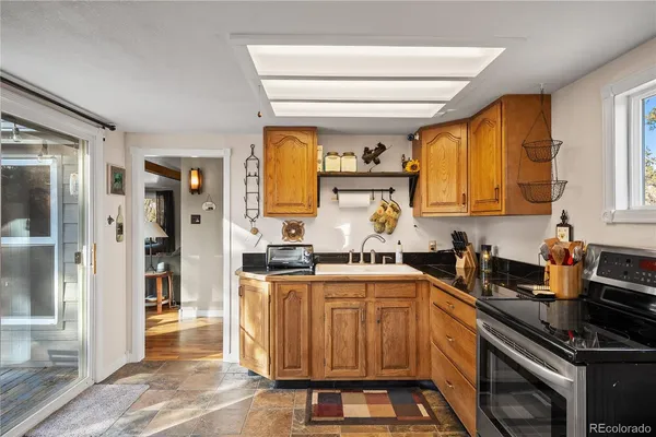 a kitchen with stainless steel appliances granite countertop a stove and cabinets