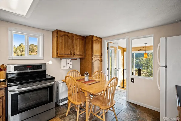 a kitchen with stainless steel appliances a stove a refrigerator and wooden cabinets