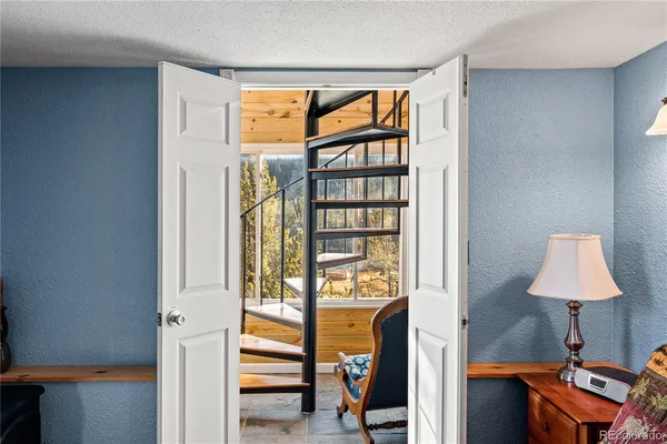 a bed sitting in a bedroom next to a window