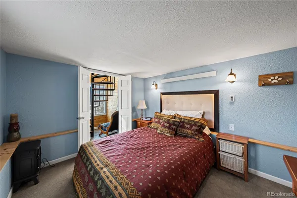 a bedroom with a bed and a tv