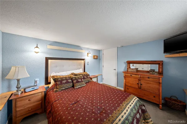 a view of walk in closet with clothes