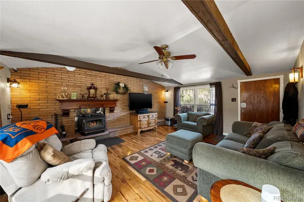a living room with furniture a flat screen tv and a large window