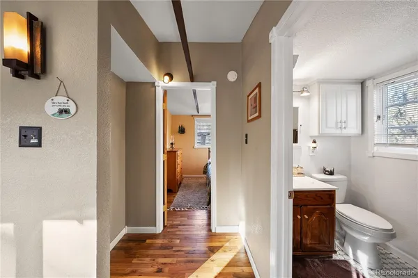 a bathroom with a toilet sink and a mirror