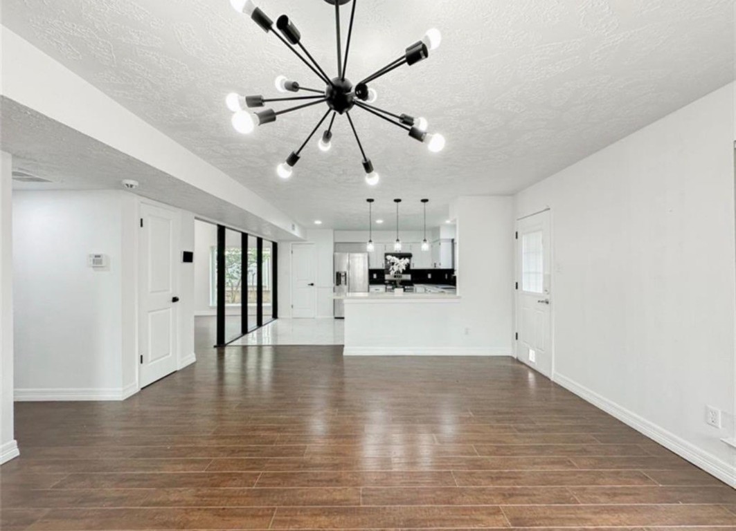 7311 Fuchsia Lane Humble, TX 77346 - Photo 16 of 38 a view of an empty room with wooden floor and a ceiling fan