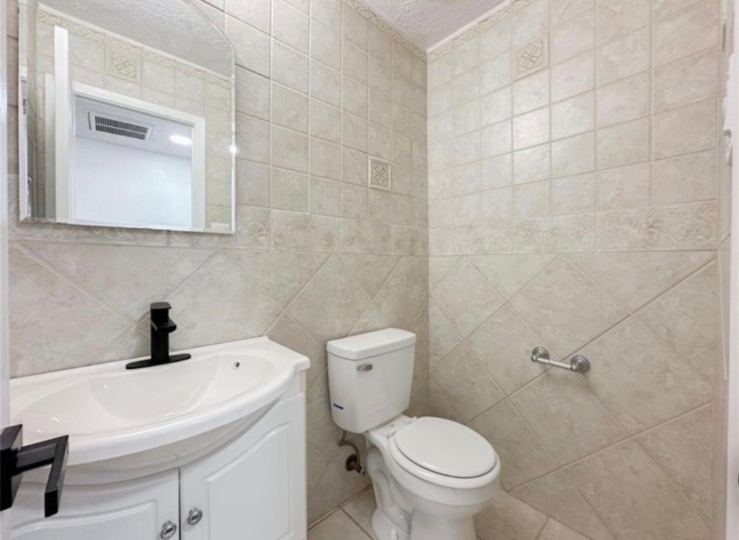 7311 Fuchsia Lane Humble, TX 77346 - Photo 19 of 38 a bathroom with a sink a toilet and a mirror
