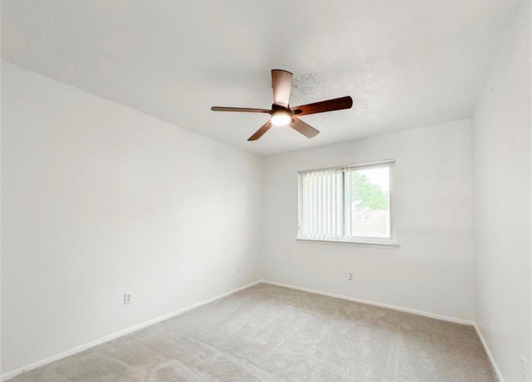 7311 Fuchsia Lane Humble, TX 77346 - Photo 20 of 38 an empty room with a window and a ceiling fan