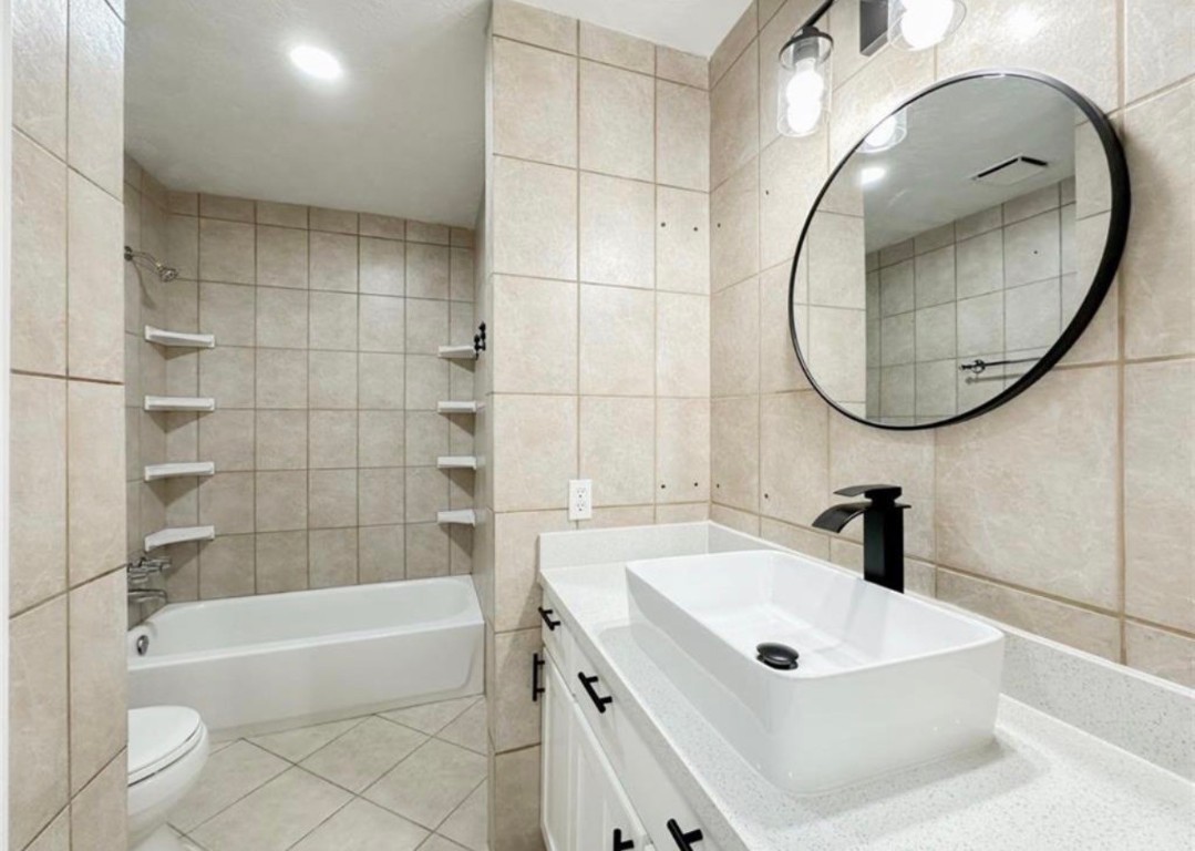 7311 Fuchsia Lane Humble, TX 77346 - Photo 26 of 38 a bathroom with a sink a toilet and bathtub