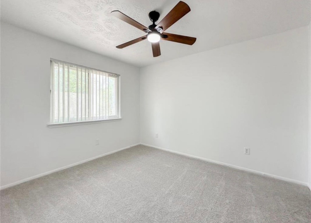 7311 Fuchsia Lane Humble, TX 77346 - Photo 30 of 38 an empty room with a window and a fan